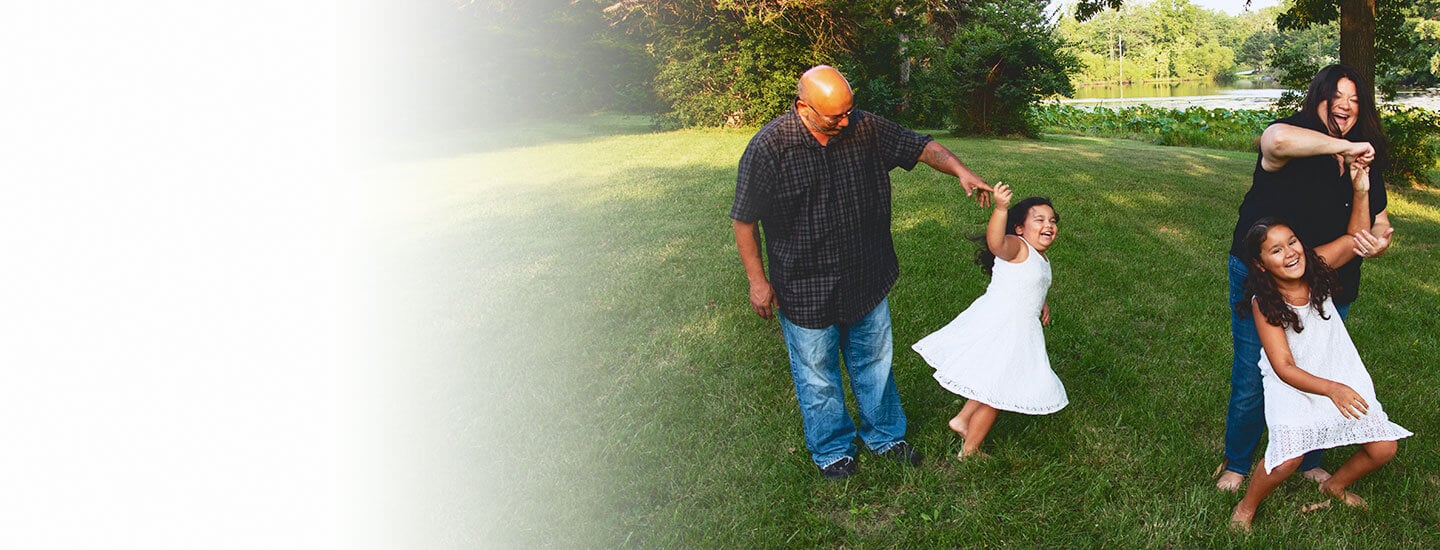 Family spending time together in a yard, symbolizing support and recovery.